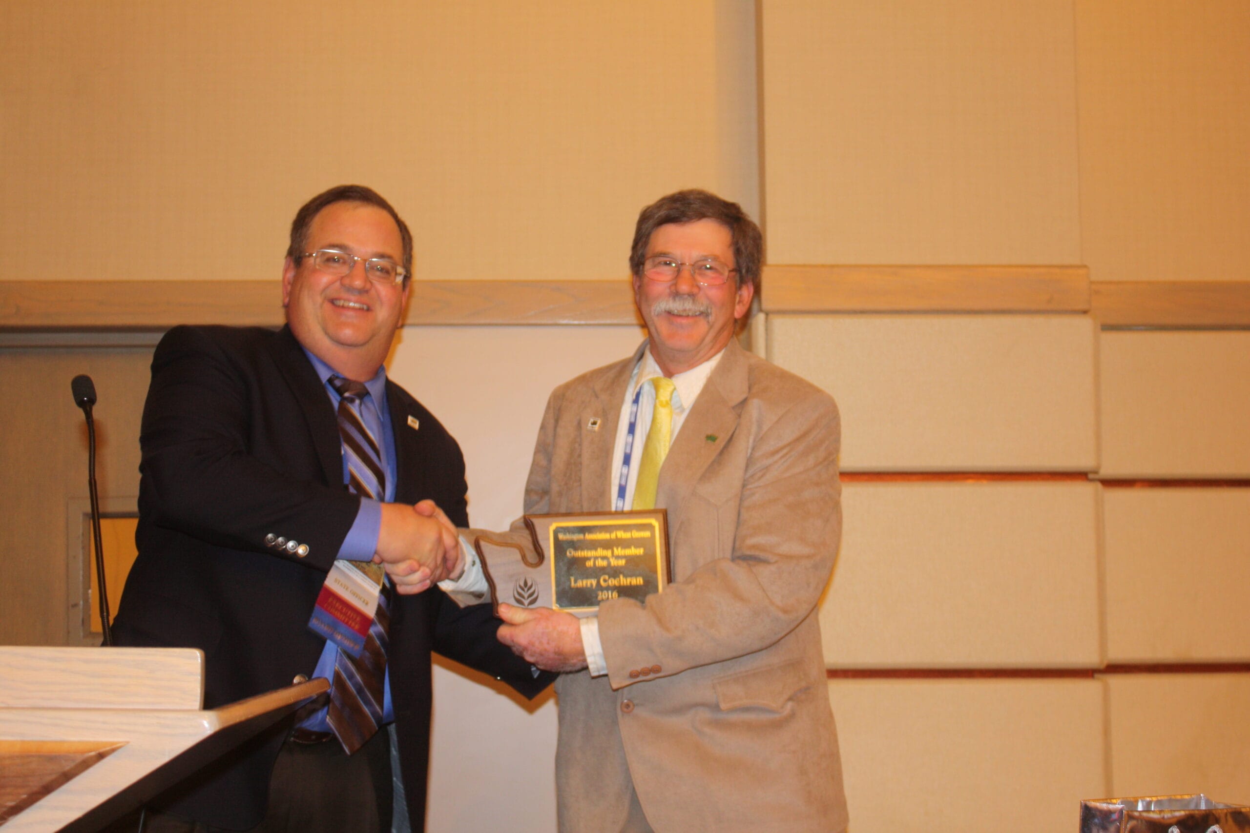 Incoming WAWG President Ben Adams (left) congratulates Larry Cochran, a farmer from Whitman County and a former WAWG president (2014/15), for being selected as the WAWG member of the year.