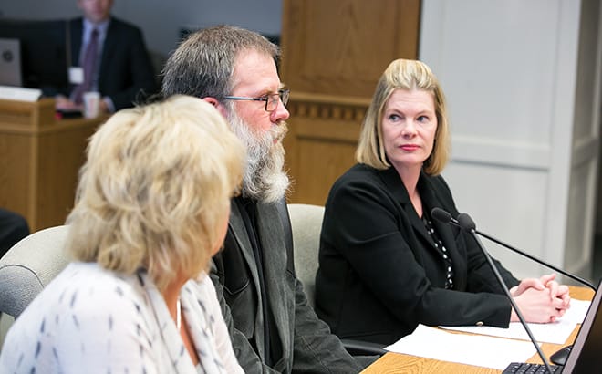 Benton County wheat grower Chad Smith (center) testifies in front of the Washington State Senate’s Agriculture, Water, Trade and Economic Development Committee during a public hearing on SB 5051, a bill relating to nondefault termination provisions in state land leases for agricultural or grazing purposes. Looking on are Washington Association of Wheat Growers Lobbyist Diana Carlen (right) and Benton County grower Nicole Berg. Photo courtesy of the Washington State Legislative Support Services.