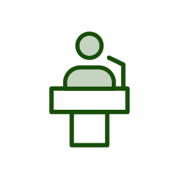 Green icon of person speaking at podium