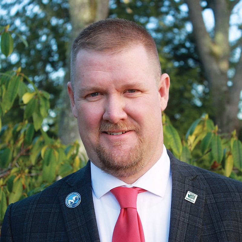 Man in suit with red tie outdoors
