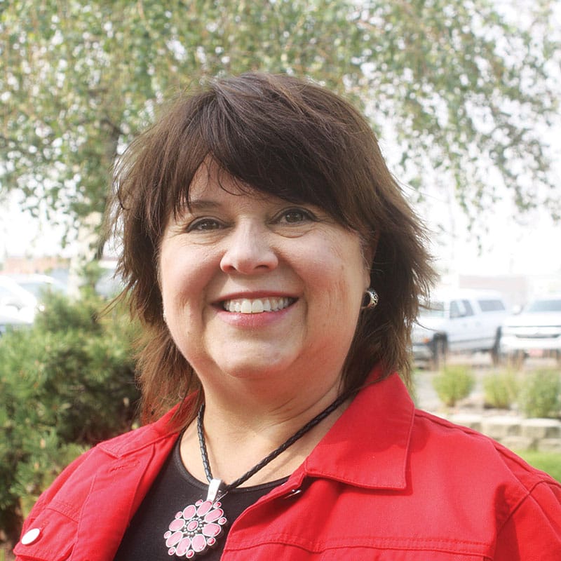 Smiling woman in red jacket outdoors